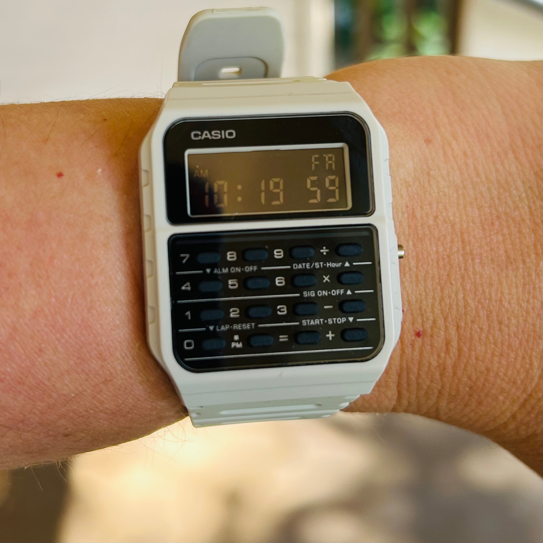 A Casio CA-53W calculator watch in beige with a negative display (and yes it’s hard to read) 